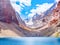 Big Alo mountain lake with turquoise water in sunshine on rocky mountain background. The Fann Mountains, Tajikistan, Central Asia