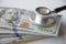 Big amount cash money with stethoscope as for health care and financial
