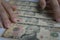 Big amount cash of one hundred US dollar bank notes putting on wooden panel background