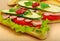Big appetizing fast food baguette sandwich with lettuce, tomato