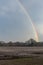 A big arching rainbow over a small countryside Suffolk village