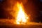 Big beautiful bonfire in the night forest in the holiday bath. Tourism and recreation in the forest against the