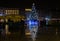 Big beautiful illuminated Christmas tree at Krakow city center, reflected on wet pavement