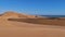 Big beige colored sand dunes with coastline of Atlantic in background near Swakopmund, Namib desert, Namibia, Africa.