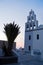 Big bell tower of Panagia church in Oia village after sunset at Santorini island