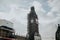 Big Ben clock with Scaffolds, during restoration works, with sun and clouds in the background, in London, England