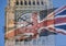 Big Ben, Clock Tower, Parliament House and British Flag merged in a double exposure shot of flag and historic London Building