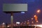 Big billboard with illumination at night, road