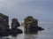 Big bird cliff rocks in atlantic ocean with seagulls and grass, sea and blue sky backgound, golden hour light, summer in nature re