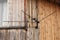 A big black antenna with a wire on the wall of a dwelling house with a white window