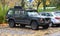 Big black veteran vintage old 4x4 offroad car Jeep Cheerokee four doors parked