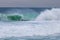 Big blue and green wave of stormy sea with cloudy sky in Barra da Tijuca Rio de Janeiro Brazil. Concept of climatic nature.