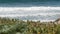 Big blue tide waves on beach, California shoreline USA. Pacific ocean coast, greenery on sea shore.