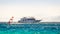 Big boat and a surfer in the sea on the background of a rocky coast in Egypt Dahab