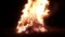 Big bonfire, night. A huge fire on a dark background.The sound of fir.Huge bonfire. Accelerated video.