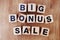 Big bonus sale text alphabet letters on wooden background