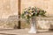 Big bouquets of colorful flowers. Luxury wedding floral decorations at the entrance of Ostuni church.