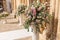 Big bouquets of colorful flowers. Luxury wedding floral decorations at the entrance of Ostuni church.