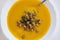 Big bowl of pumpkin soup on white background.