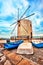 A big brick windmill with three old fish boats, Corfu, Greece