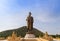 Big bronze buddha statue standing in wat thipsukhontharam public thai temple