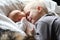 Big Brother Hugging Newborn Baby with Love