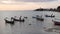 Big Buddha temple surrounded by calm water and old Muslim fishing longtail boats on seaside of Samui paradise tropical