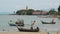 Big Buddha temple surrounded by calm water and old Muslim fishing longtail boats on seaside of Samui paradise tropical