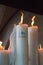 Big candles with glowing flame in Sanctuary of Lourdes. Burning candles. Faith and prayer concept. Religious symbol.