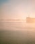 Big cargo ship covered by fog at Parana River, in Rosario, Argentina during sunrise