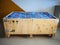 Big cargo wooden crate up-cycled into a sofa to match the industrial interior design in an