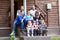 Big Caucasian family with children sitting on the house porch