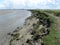 A big channel with low tide in a salt marsh area at the dutch coast