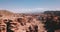 Big Charyn canyon and a young couple in white. Red rocks of different breeds