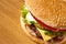 Big Cheeseburger Close up on Wooden Table