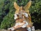 Big Christmas angel with golden wings and lush robe in gold and beige