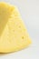 Big Chunk Wedge of Alpine Creamy Appetizing Light Yellow Tilsit Cheese on White Background. Texture with Cracks and Holes