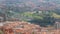 Big city with many buildings at bottom of green mountains, Bilbao, aerial view
