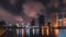 Big city in the night life with reflection of water wave. Long exposure Technics. Panorama of landscape.Town and urban concept.