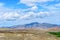 Big cloud lying on a hilltop