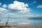 Big clouds reflecting on the smooth water surface. Warm autumn day near the lake or a sea.