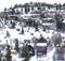 Big colorful and beautiful houses in a snowy mountainside with lots of trees