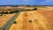 Big combine harvesting field in Poland in summer, aerial view