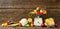 Big composition of fresh autumn vegetables on a wood long banner brown background