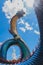 The big concrete symbol of Phaya Naga, serpent dragon with the big buddha background, The public property at Wat Phumanorom,