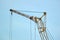 Big construction crane part on blue sky background