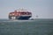 Big container ship sailing with tugboat into Dutch harbor Rotterdam