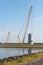 Big crane busy with construction of a new Dutch windturbine