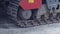 Big crawler tractor close-up rides on asphalt