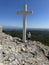 Big cross against the background of the sea. A man near the Christian monument Cross of Jesus. Croatia, Ugljan island, near the